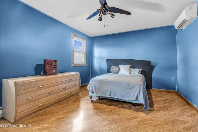 1341 1st Ave, Toms River, NJ 08757 - bedroom with an AC wall unit, light wood-type flooring, and a ceiling fan