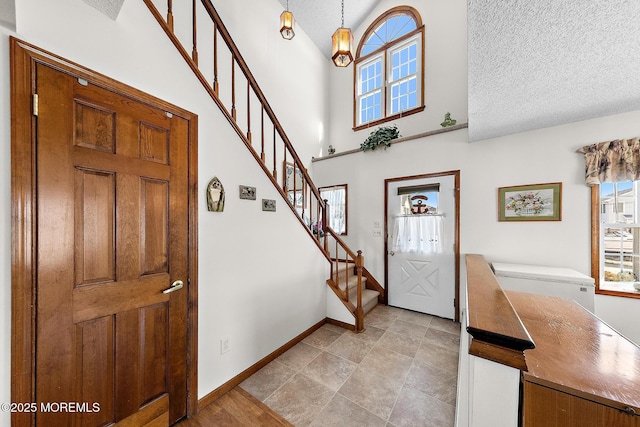 8 Mary Alice Rd, Beach Haven West, NJ 08050 - entrance foyer with healthy amount of natural light, a high ceiling, stairs, and a textured ceiling