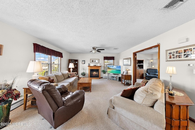 8 Mary Alice Rd, Beach Haven West, NJ 08050 - carpeted living area with a ceiling fan, a textured ceiling, a baseboard radiator, and a warm lit fireplace