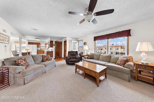 8 Mary Alice Rd, Beach Haven West, NJ 08050 - living room featuring ceiling fan, light carpet, and a textured ceiling