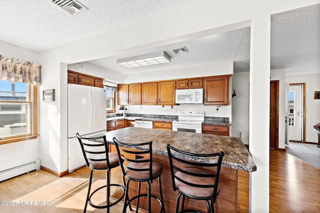 8 Mary Alice Rd, Beach Haven West, NJ 08050 - kitchen featuring white appliances, healthy amount of natural light, a textured ceiling, light wood-style floors, and a baseboard radiator