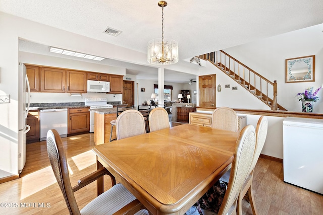 8 Mary Alice Rd, Beach Haven West, NJ 08050 - dining room with a chandelier, light wood-style floors, and stairway