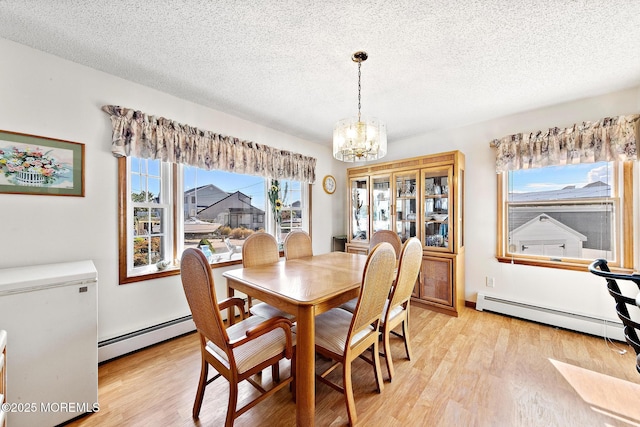 8 Mary Alice Rd, Beach Haven West, NJ 08050 - dining room featuring baseboard heating, a chandelier, light wood-style flooring, and a textured ceiling