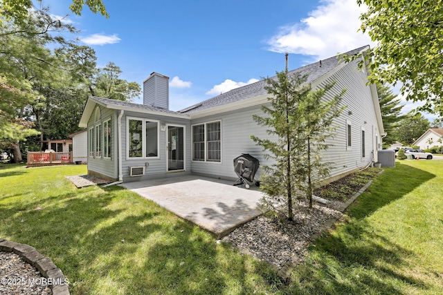 1887 Crimson Ct, Toms River, NJ 08755 - back of property featuring a patio area, a lawn, a chimney, and roof with shingles