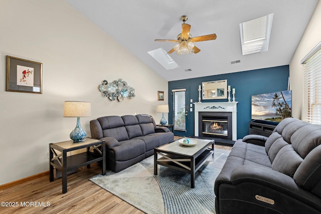 1887 Crimson Ct, Toms River, NJ 08755 - living area with ceiling fan, a skylight, lofted ceiling, wood finished floors, and a glass covered fireplace