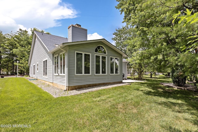 1887 Crimson Ct, Toms River, NJ 08755 - view of home's exterior with a chimney and a lawn