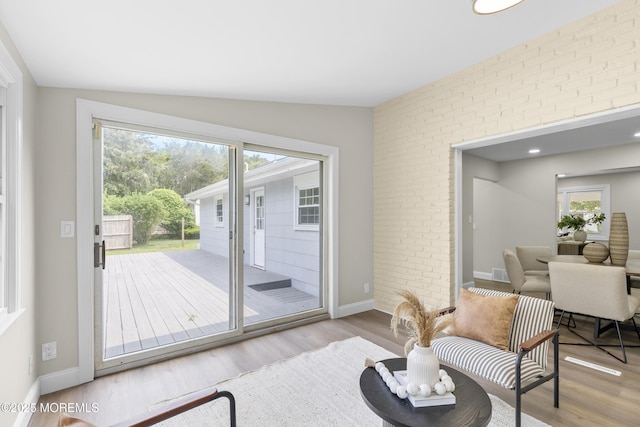 13 Pinehurst Dr, Little Egg Harbor, NJ 08087 - living area with wood finished floors, brick wall, and lofted ceiling