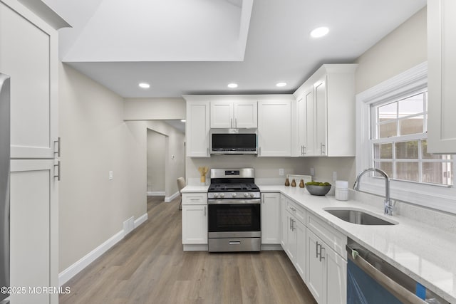 13 Pinehurst Dr, Little Egg Harbor, NJ 08087 - kitchen featuring appliances with stainless steel finishes, white cabinetry, wood finished floors, light stone counters, and recessed lighting
