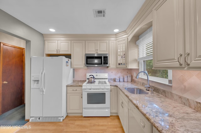 24 Roosevelt Dr, Brick, NJ 08724 - kitchen featuring white appliances, light stone counters, light wood-style flooring, tasteful backsplash, and cream cabinetry