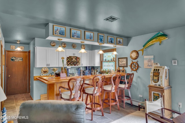 24 Roosevelt Dr, Brick, NJ 08724 - kitchen with white cabinets, pendant lighting, and a baseboard radiator