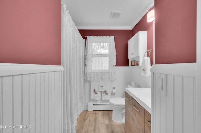 24 Roosevelt Dr, Brick, NJ 08724 - bathroom featuring baseboard heating, a wainscoted wall, vanity, wood finished floors, and crown molding