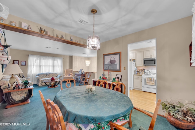24 Roosevelt Dr, Brick, NJ 08724 - dining space with a chandelier and light carpet