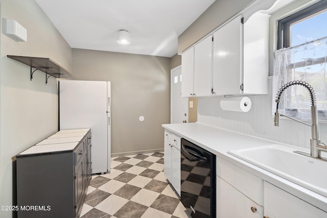301 Spring St Unit 19, Red Bank, NJ 07701 - kitchen with black dishwasher, white cabinets, light countertops, open shelves, and freestanding refrigerator