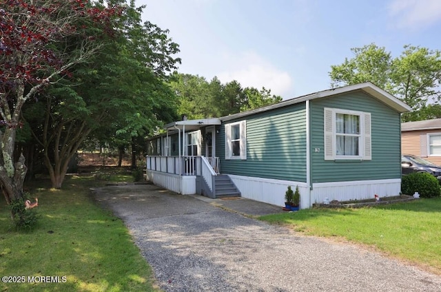 147 Redwood Dr, Barnegat, NJ 08005 - manufactured / mobile home with asphalt driveway and a front lawn
