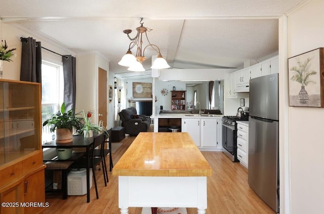 147 Redwood Dr, Barnegat, NJ 08005 - kitchen with stainless steel appliances, butcher block counters, under cabinet range hood, light wood-style flooring, and white cabinetry