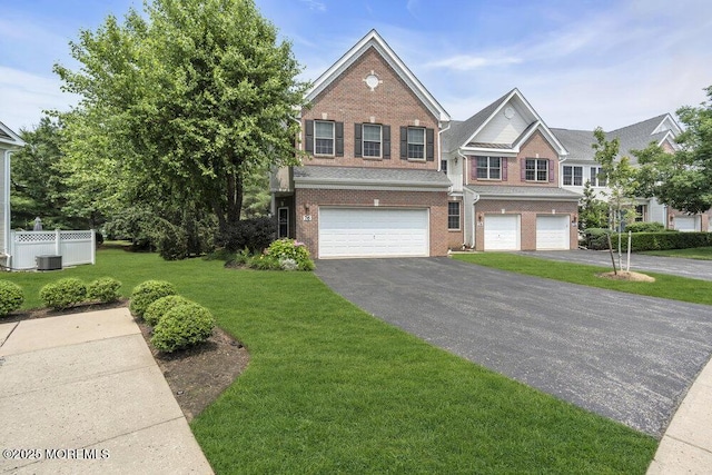 76 Deepwater Cir, Manalapan, NJ 07726 - view of front of property featuring brick siding, a garage, and asphalt driveway