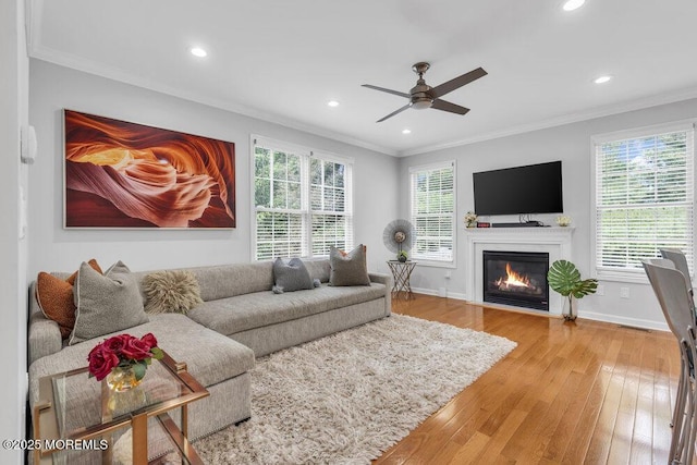 76 Deepwater Cir, Manalapan, NJ 07726 - living room featuring ornamental molding, recessed lighting, plenty of natural light, ceiling fan, and a fireplace with flush hearth