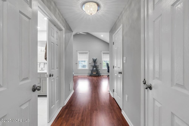 76 Deepwater Cir, Manalapan, NJ 07726 - hallway featuring dark wood-type flooring, a chandelier, and vaulted ceiling