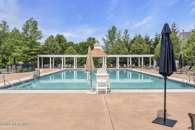 76 Deepwater Cir, Manalapan, NJ 07726 - community pool with a pergola, a patio, and view of scattered trees