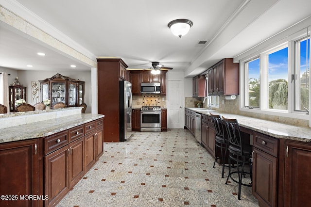 16 8th Ave, Monroe, NJ 08831 - kitchen featuring appliances with stainless steel finishes, backsplash, recessed lighting, ceiling fan, and light stone counters
