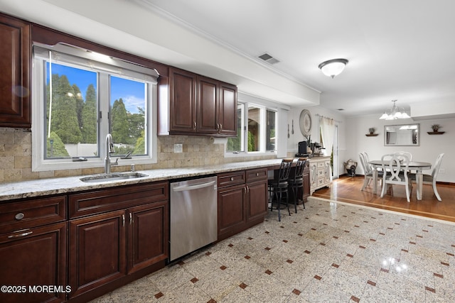 16 8th Ave, Monroe, NJ 08831 - kitchen with stainless steel dishwasher, decorative backsplash, a chandelier, light stone countertops, and crown molding