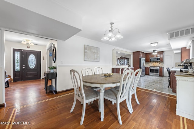 16 8th Ave, Monroe, NJ 08831 - dining room with a chandelier, dark wood-style floors, and crown molding