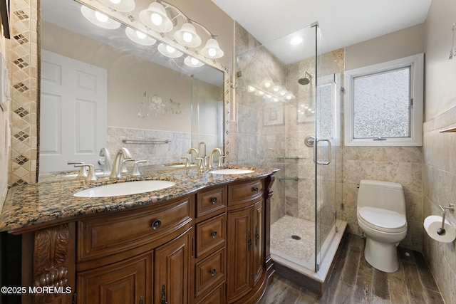 16 8th Ave, Monroe, NJ 08831 - full bath with tile walls, wood finished floors, a shower stall, and double vanity