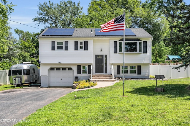 180 Grand Ave, Atlantic Highlands, NJ 07716 - raised ranch with asphalt driveway, roof mounted solar panels, and a garage