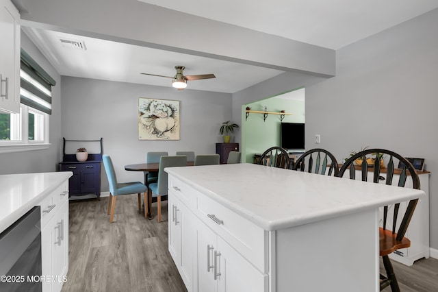 180 Grand Ave, Atlantic Highlands, NJ 07716 - kitchen featuring a breakfast bar, light wood-type flooring, a center island, ceiling fan, and white cabinetry