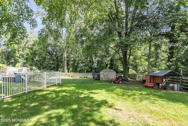 180 Grand Ave, Atlantic Highlands, NJ 07716 - fenced backyard featuring exterior structure, an outdoor structure, and view of wooded area