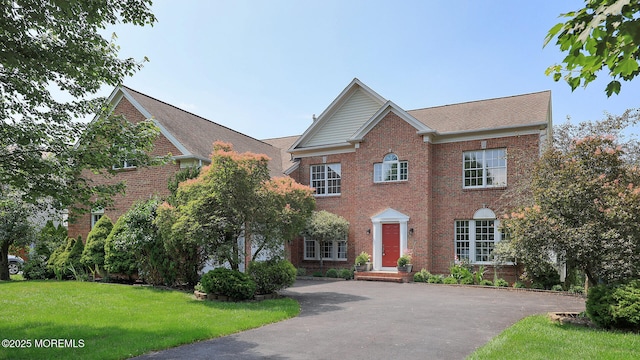 18 Sage St, Holmdel, NJ 07733 - colonial house featuring brick siding, a front lawn, and driveway