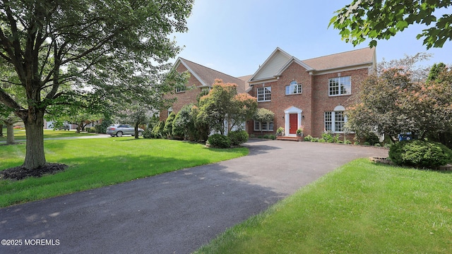 18 Sage St, Holmdel, NJ 07733 - colonial-style house featuring brick siding, driveway, and a front lawn