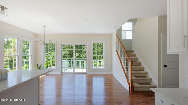 18 Sage St, Holmdel, NJ 07733 - unfurnished living room with stairs, dark wood-type flooring, plenty of natural light, a chandelier, and recessed lighting