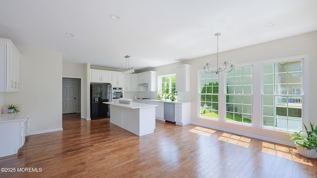 18 Sage St, Holmdel, NJ 07733 - kitchen with stainless steel appliances, a chandelier, wood finished floors, a center island, and white cabinets