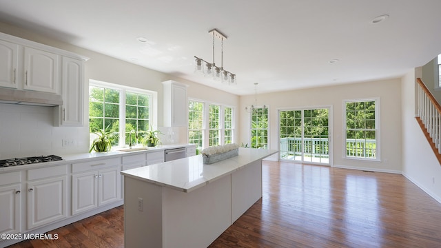 18 Sage St, Holmdel, NJ 07733 - kitchen featuring gas cooktop, under cabinet range hood, dishwasher, a center island, and backsplash
