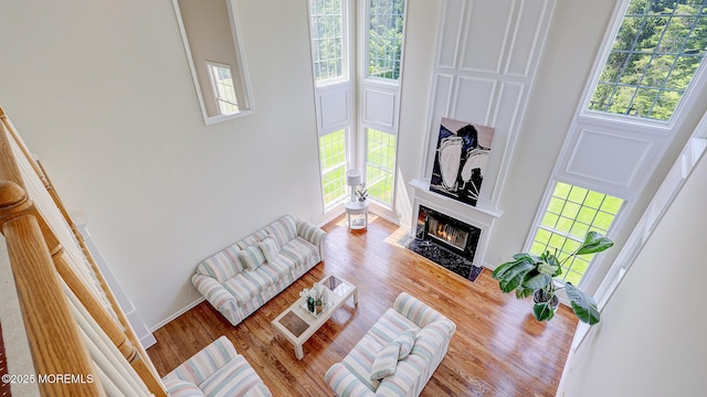 18 Sage St, Holmdel, NJ 07733 - living area with a high ceiling, a fireplace with flush hearth, and wood finished floors