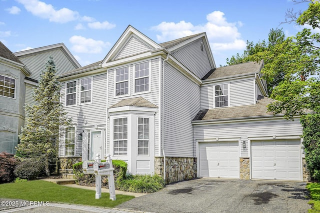 9 Mioduski Ct, Parlin, NJ 08859 - view of front facade with driveway, stone siding, and a shingled roof