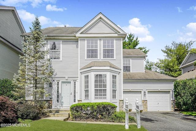 9 Mioduski Ct, Parlin, NJ 08859 - view of front facade featuring driveway and a shingled roof