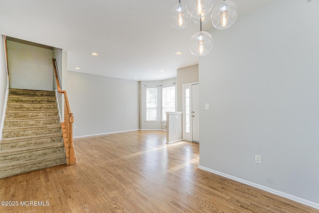 9 Mioduski Ct, Parlin, NJ 08859 - unfurnished living room featuring light wood-type flooring, stairs, a chandelier, and recessed lighting