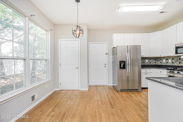 9 Mioduski Ct, Parlin, NJ 08859 - kitchen with stainless steel appliances, light wood-style flooring, white cabinetry, and decorative backsplash
