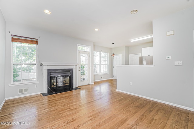 9 Mioduski Ct, Parlin, NJ 08859 - unfurnished living room featuring light wood-style flooring, a premium fireplace, and recessed lighting