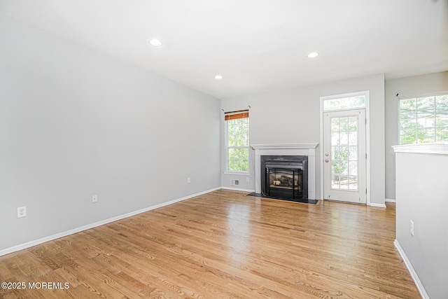 9 Mioduski Ct, Parlin, NJ 08859 - unfurnished living room featuring a fireplace with flush hearth, healthy amount of natural light, light wood-style floors, and recessed lighting