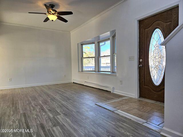 19 Sunrise Blvd, Forked River, NJ 08731 - foyer entrance featuring a baseboard radiator, healthy amount of natural light, crown molding, ceiling fan, and wood finished floors