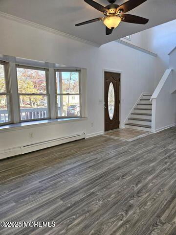 19 Sunrise Blvd, Forked River, NJ 08731 - entrance foyer featuring stairway, wood finished floors, baseboard heating, a ceiling fan, and ornamental molding