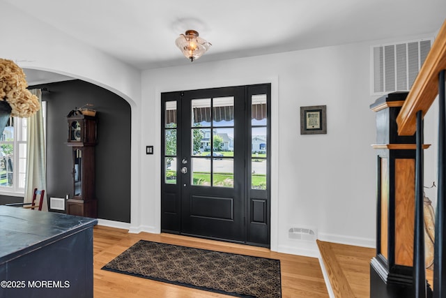 1510 Bel Aire Ct E, Point Pleasant, NJ 08742 - entrance foyer with arched walkways, plenty of natural light, and light wood finished floors