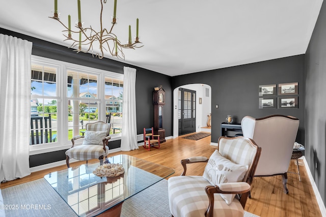 1510 Bel Aire Ct E, Point Pleasant, NJ 08742 - living room featuring arched walkways, a chandelier, and wood finished floors