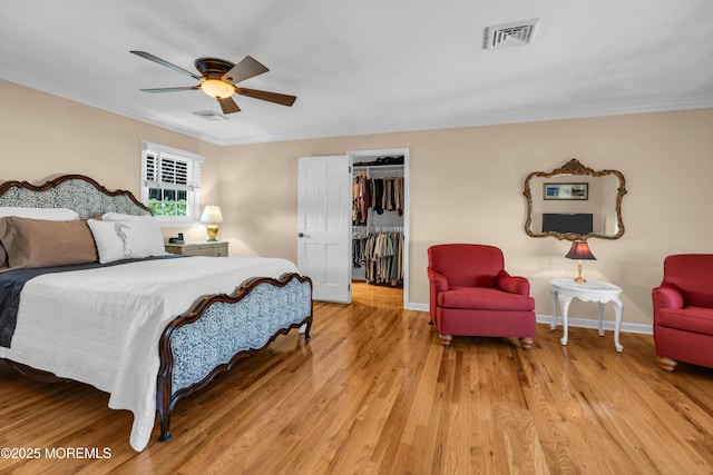 1510 Bel Aire Ct E, Point Pleasant, NJ 08742 - bedroom featuring crown molding, light wood-style floors, a walk in closet, and ceiling fan