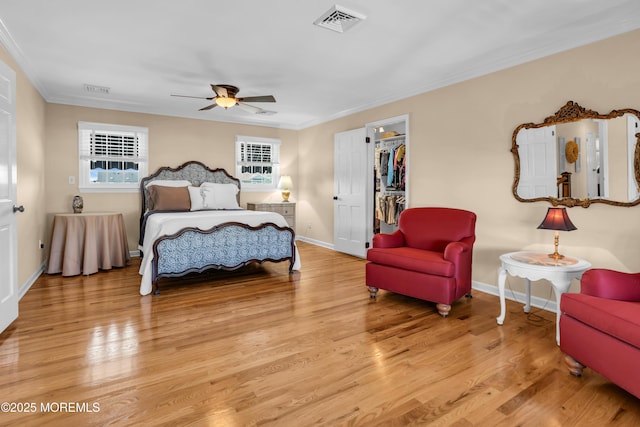 1510 Bel Aire Ct E, Point Pleasant, NJ 08742 - bedroom featuring crown molding, wood finished floors, a walk in closet, and ceiling fan