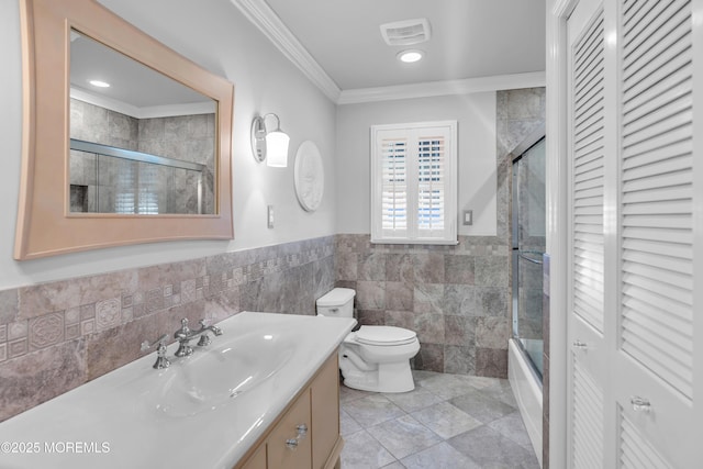 1510 Bel Aire Ct E, Point Pleasant, NJ 08742 - full bath featuring tile walls, crown molding, vanity, combined bath / shower with glass door, and a wainscoted wall