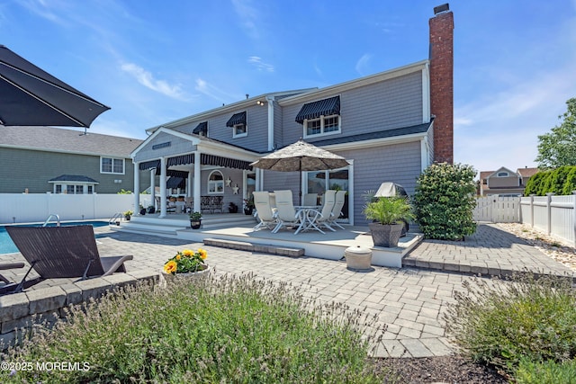 1510 Bel Aire Ct E, Point Pleasant, NJ 08742 - back of house with a patio area, a chimney, a gazebo, and a fenced backyard
